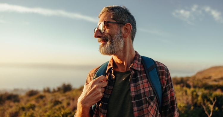 A man looks out as he takes a hike