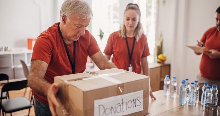 A retiree boxes up donation