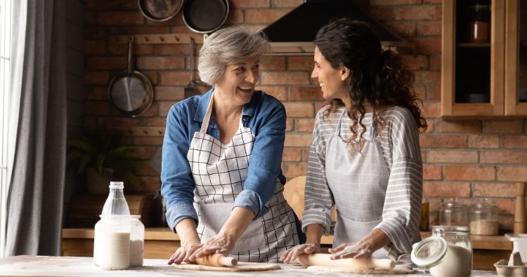 A mother and daughter bake together.