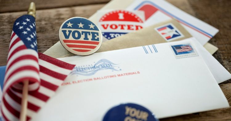 An American flag with mail-in ballots