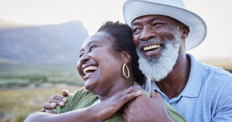 A retired couple look out over a valley together